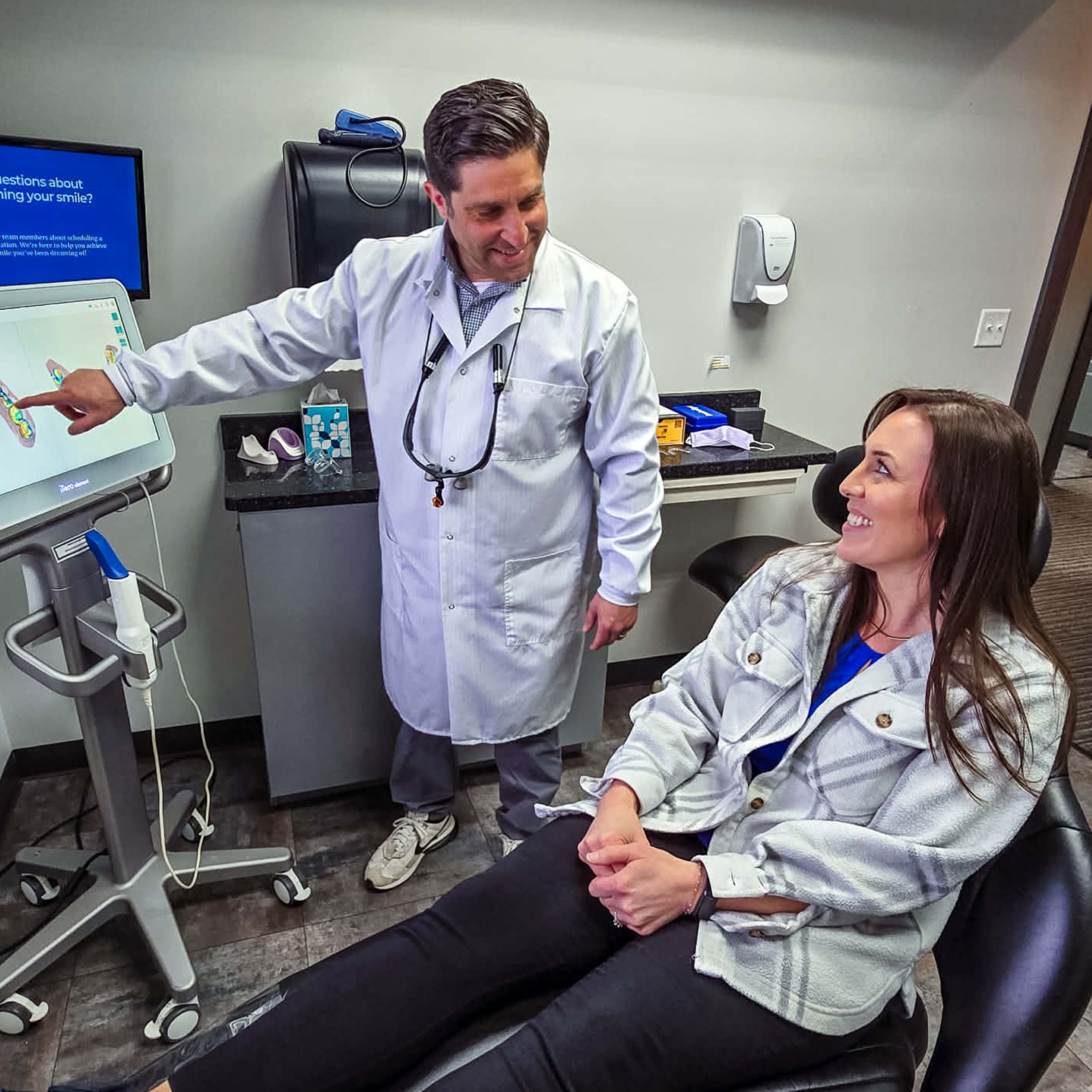 Doctor showing a patient iTero technology during a treatment discussion