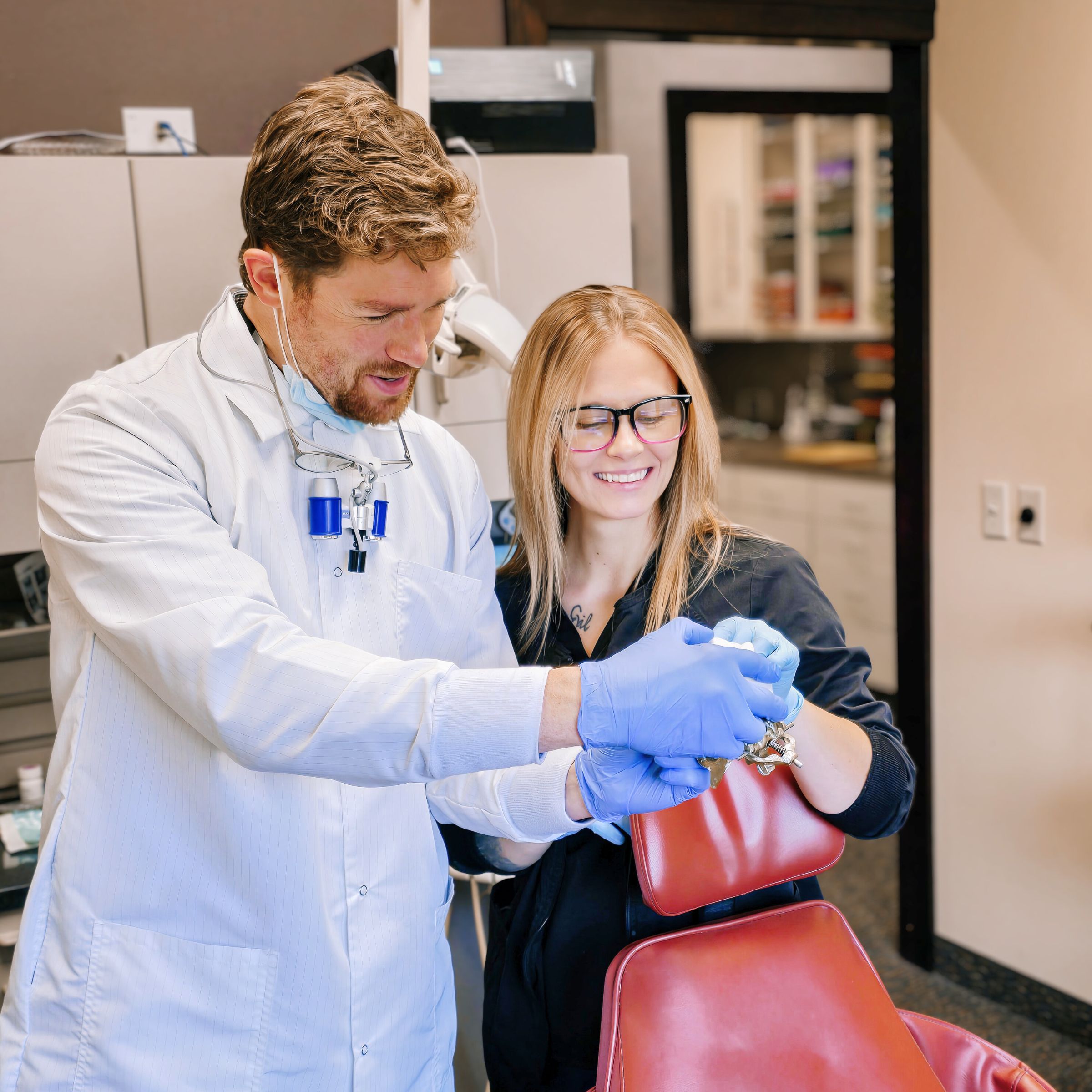 MI Smiles Dental Group doctor with patient explaining treatment