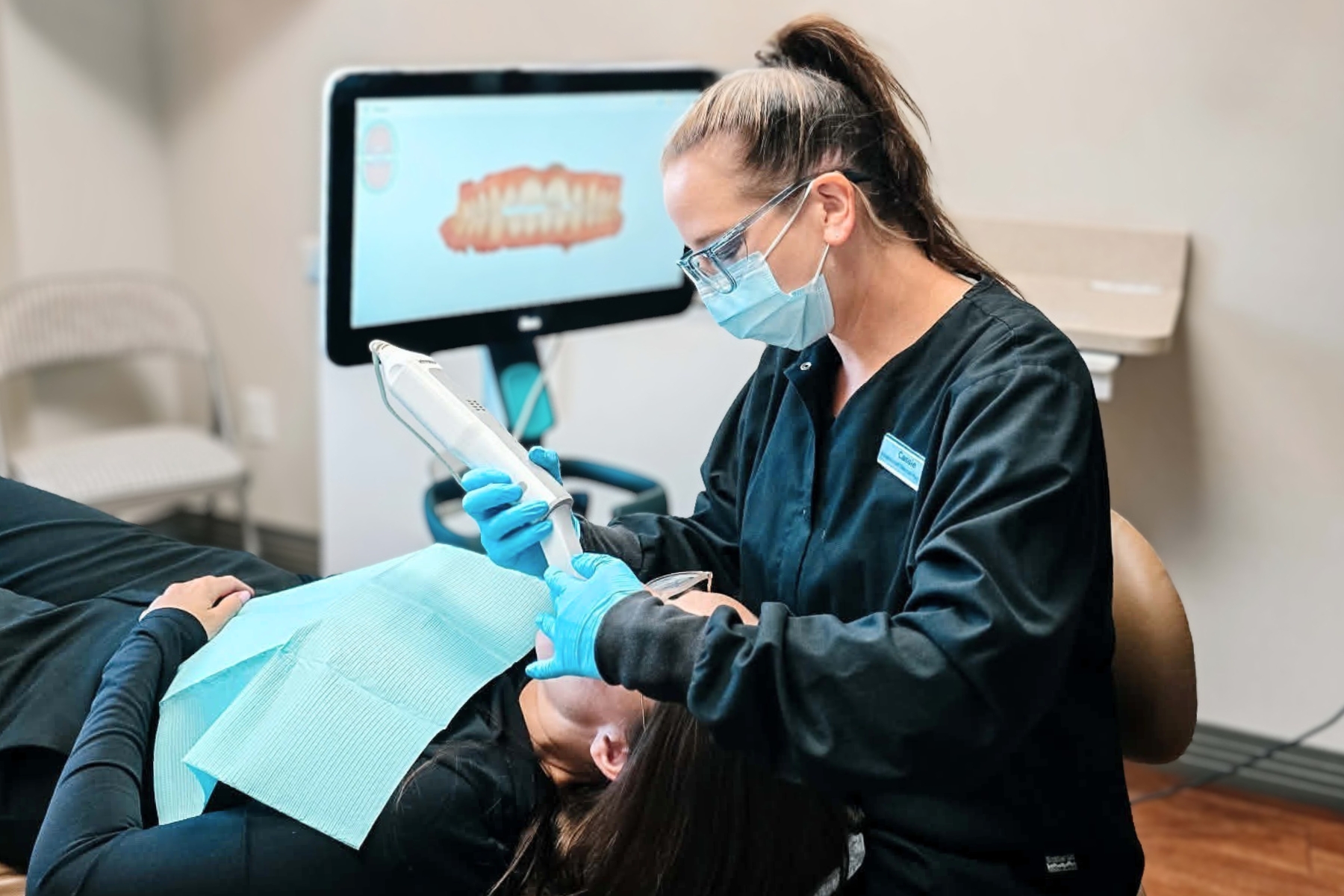 A dental hygienist using an iTero digital scanner